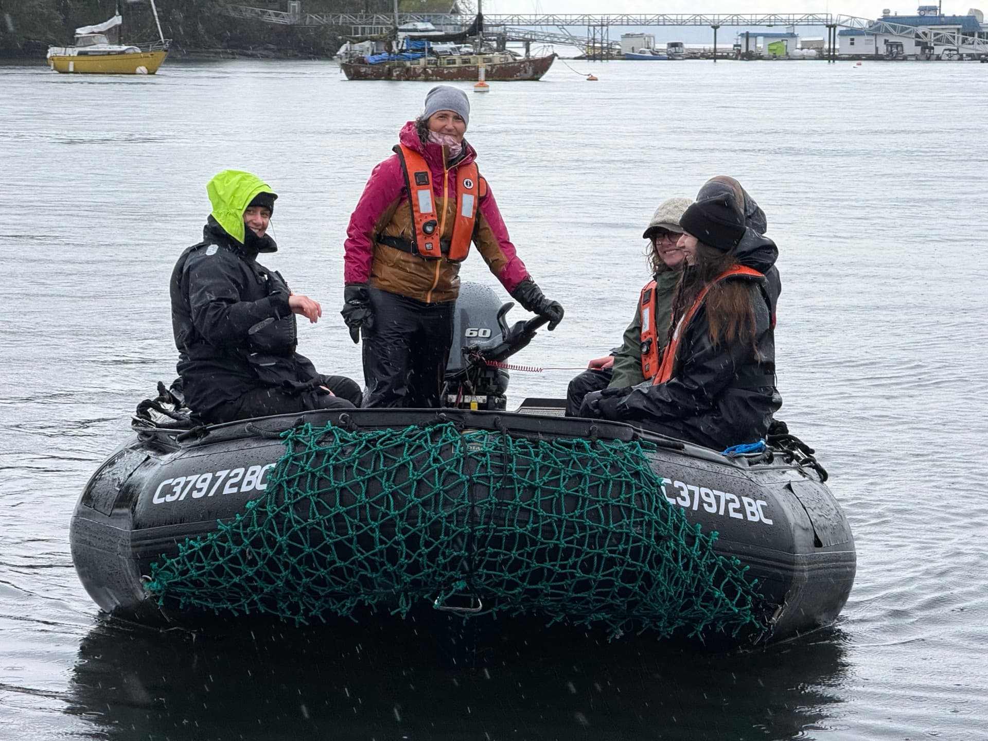 Passengers in life jackets aboard the Zodiac — hands-on training